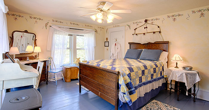 Quaint bedroom with antique wooden bed.
