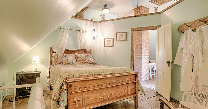 Rustic attic bedroom with antique bed.