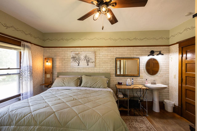 Rustic bedroom with a comfortable queen bed.