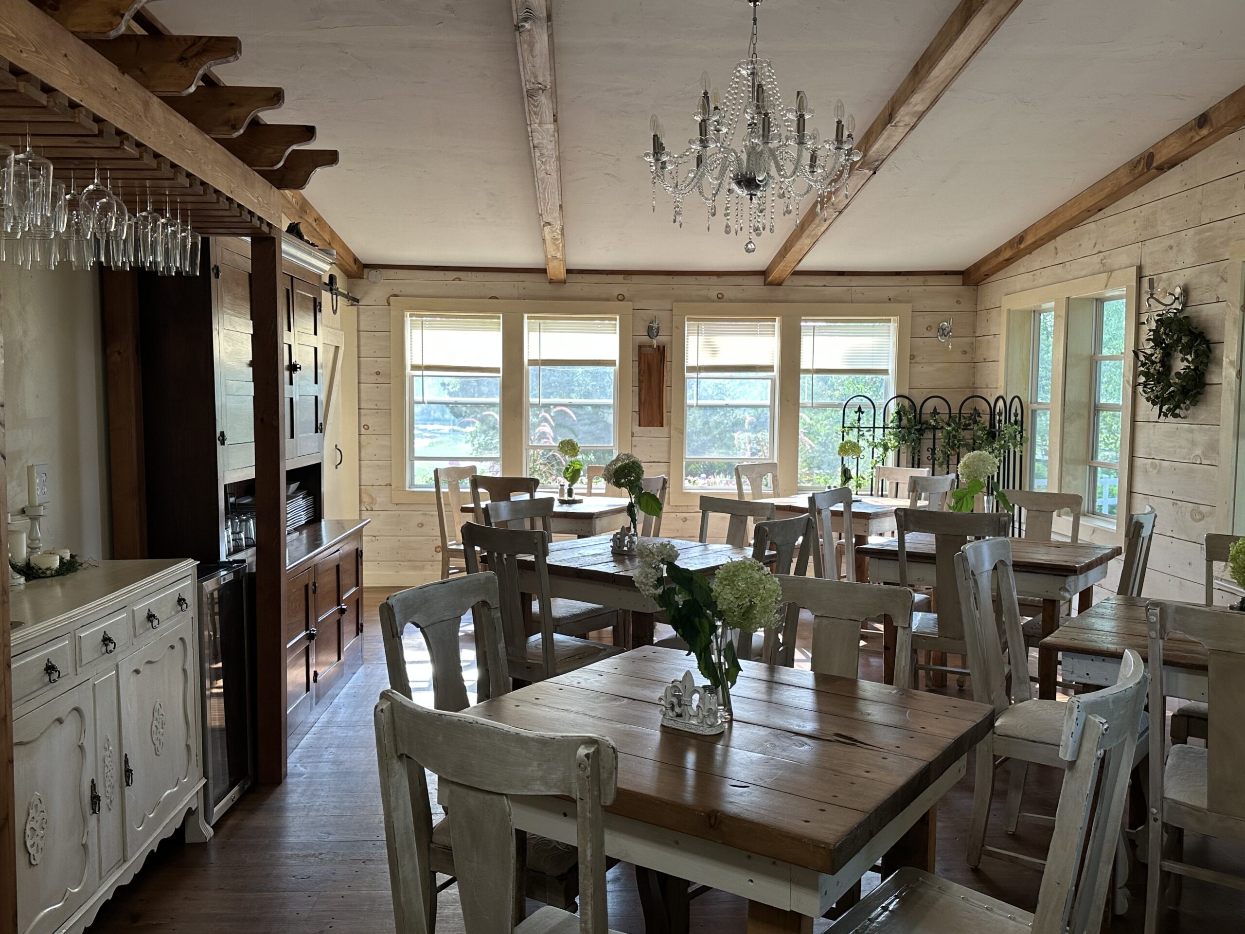 Rustic farm dining room with long tables.